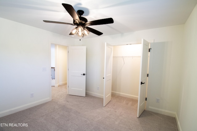 unfurnished bedroom featuring light colored carpet, ceiling fan, and a closet