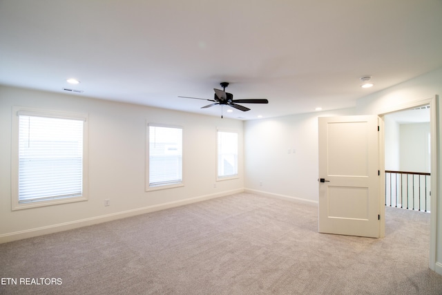 empty room with ceiling fan, visible vents, baseboards, light carpet, and recessed lighting