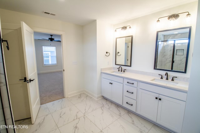bathroom with a sink, a shower stall, marble finish floor, and visible vents
