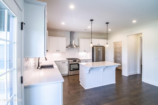 kitchen featuring a sink, wall chimney exhaust hood, decorative backsplash, and stainless steel appliances