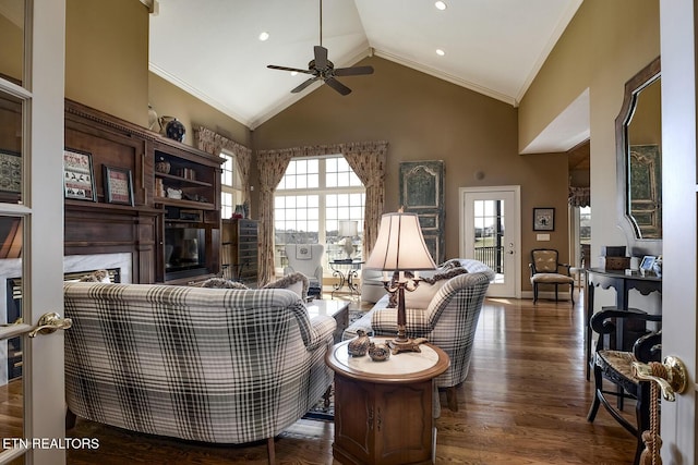 living room with crown molding, a fireplace, wood finished floors, high vaulted ceiling, and a ceiling fan