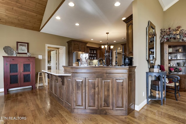 kitchen with a chandelier, recessed lighting, stainless steel refrigerator with ice dispenser, and wood finished floors