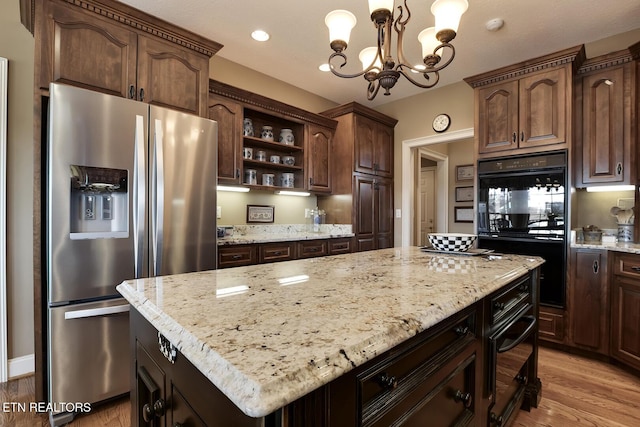 kitchen with a kitchen island, stainless steel fridge with ice dispenser, light wood-style flooring, dobule oven black, and open shelves