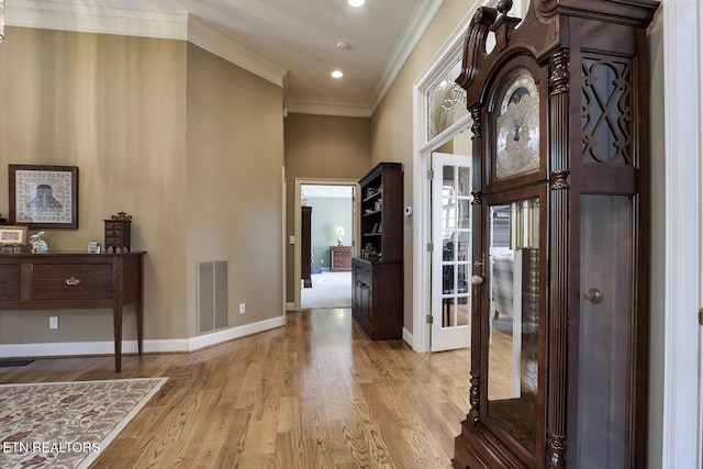 entrance foyer featuring baseboards, visible vents, light wood finished floors, recessed lighting, and ornamental molding