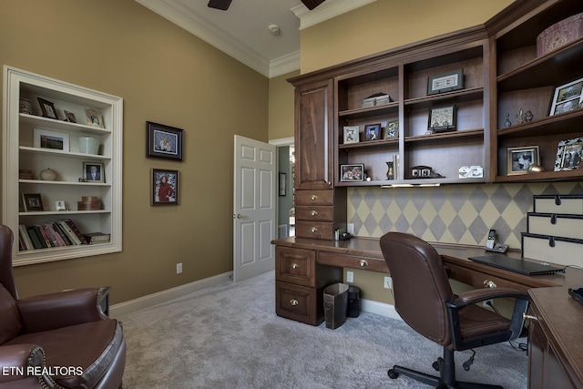 office featuring crown molding, a ceiling fan, baseboards, and light carpet