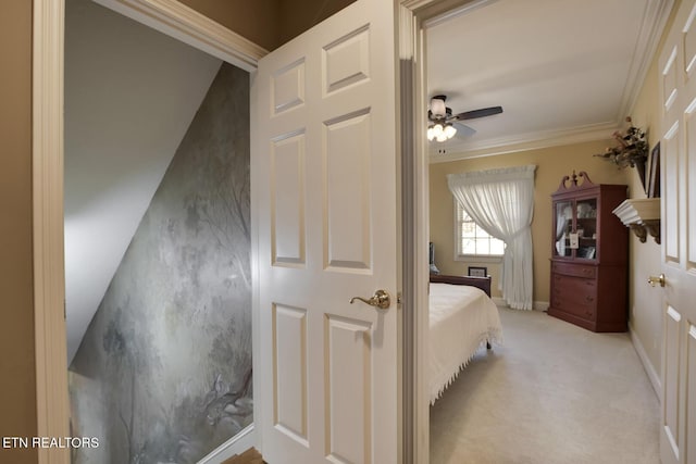 bedroom with crown molding and light carpet