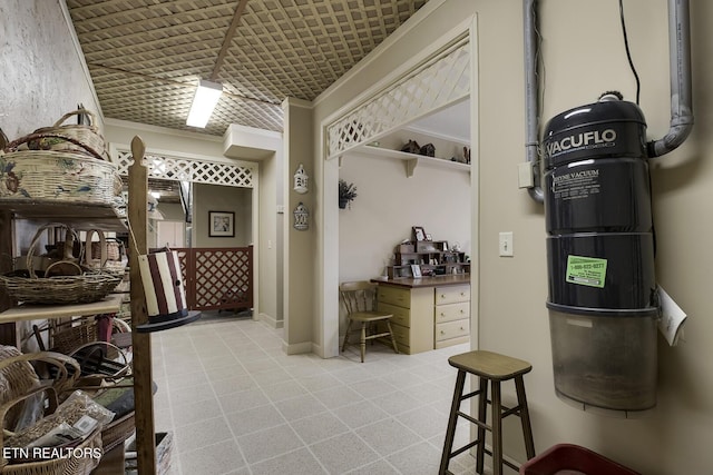 interior space with baseboards, light colored carpet, and crown molding