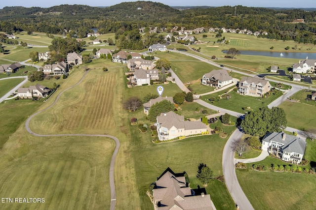 aerial view featuring view of golf course, a water view, and a residential view