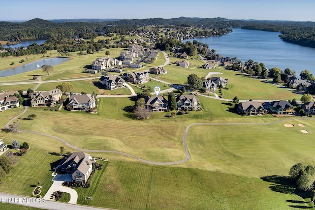 drone / aerial view with a residential view, a water view, and golf course view