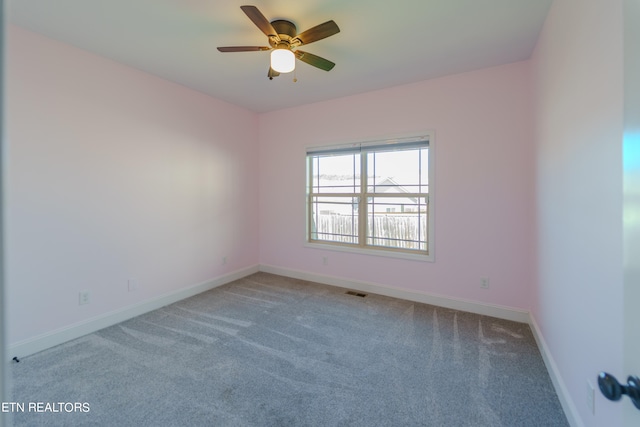 spare room with ceiling fan and carpet