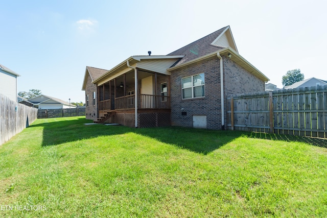 back of house featuring a lawn