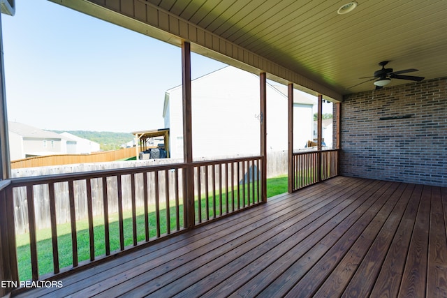 wooden deck with ceiling fan and a yard