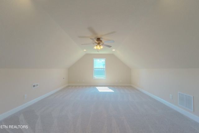 additional living space featuring lofted ceiling, ceiling fan, and light carpet