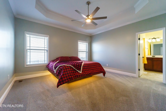 bedroom featuring ornamental molding, ceiling fan, connected bathroom, and light colored carpet