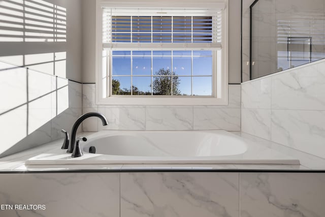 bathroom featuring tiled bath