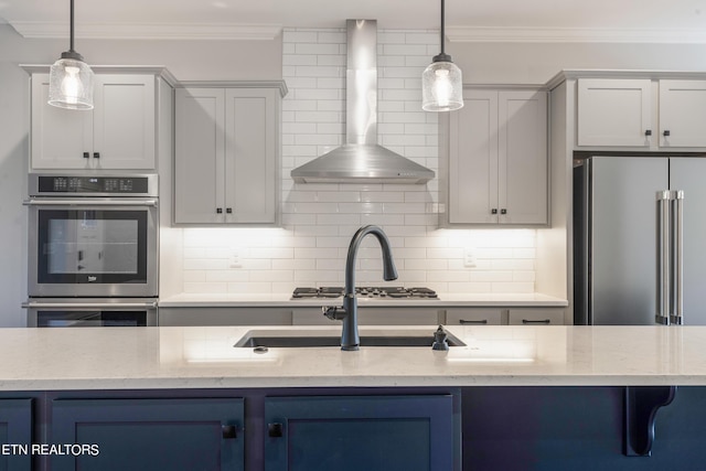 kitchen with decorative backsplash, wall chimney exhaust hood, light stone counters, and stainless steel appliances
