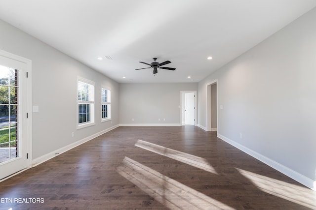 unfurnished room with ceiling fan, plenty of natural light, and dark hardwood / wood-style flooring