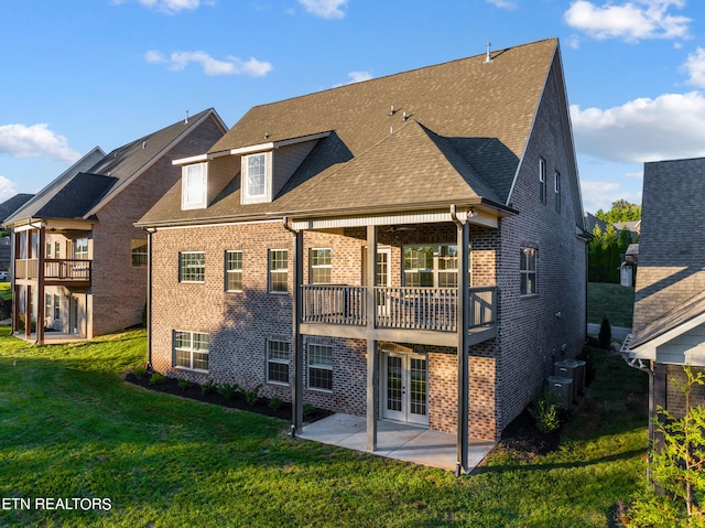 back of property featuring a lawn and a patio area