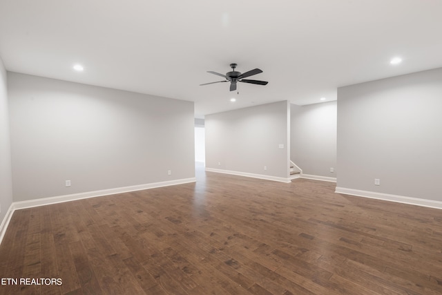 spare room featuring ceiling fan and dark wood-type flooring