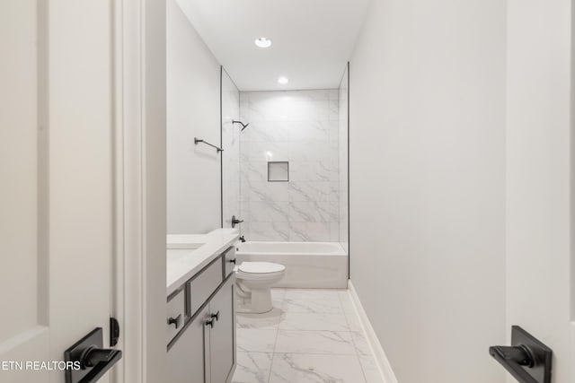 full bathroom with tiled shower / bath, vanity, and toilet