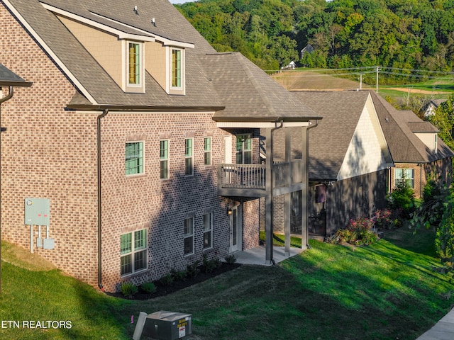 back of property featuring a lawn