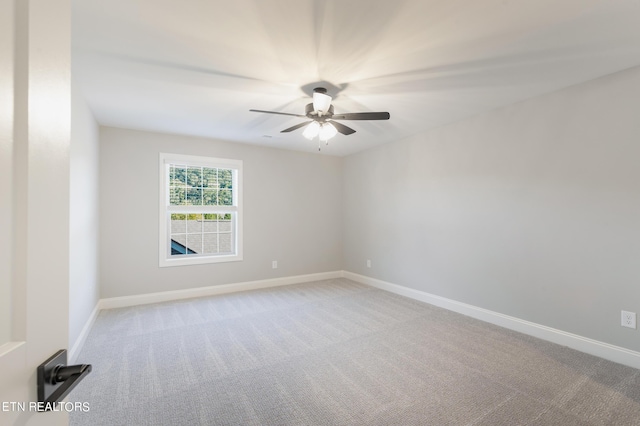 spare room featuring carpet flooring, baseboards, and a ceiling fan