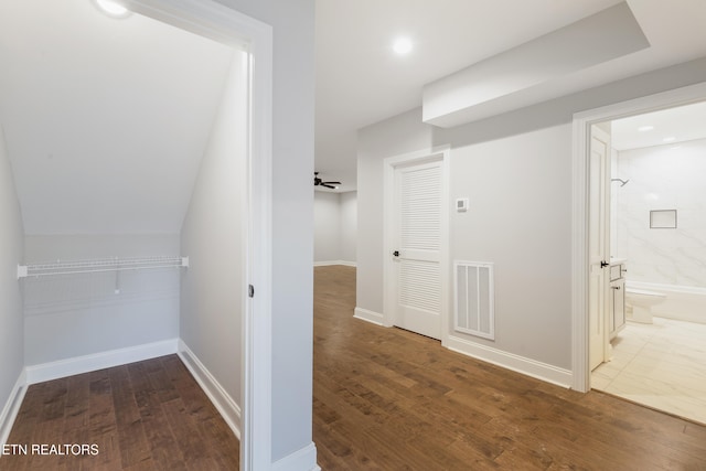 corridor with dark hardwood / wood-style flooring