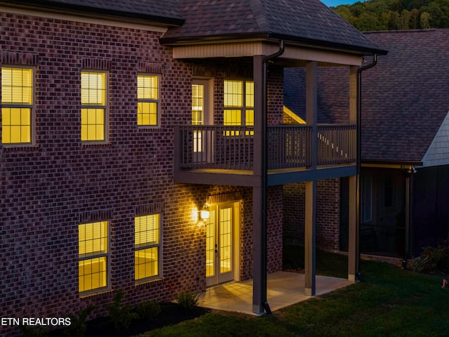 back of property with a patio and a balcony