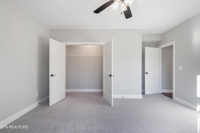 unfurnished bedroom with a closet, light carpet, and ceiling fan