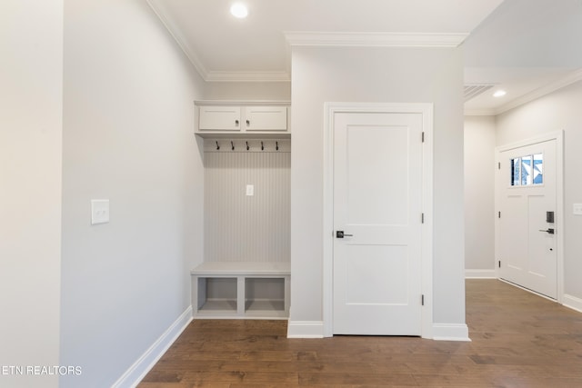 mudroom featuring dark wood-type flooring and crown molding