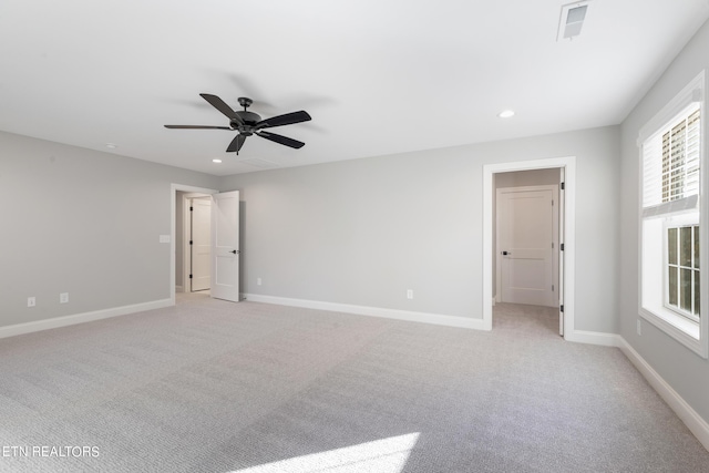 unfurnished bedroom featuring light carpet, a ceiling fan, baseboards, and recessed lighting