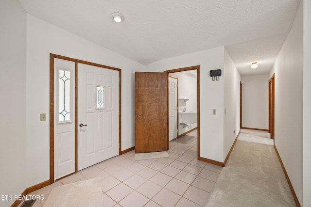 tiled foyer entrance featuring a textured ceiling