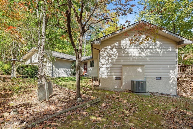 back of house with central AC unit