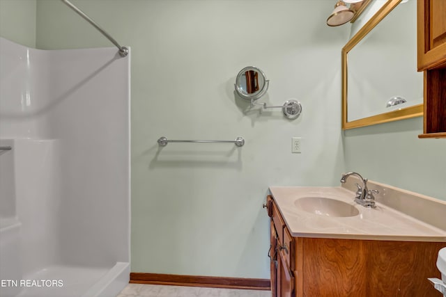 bathroom with vanity and walk in shower