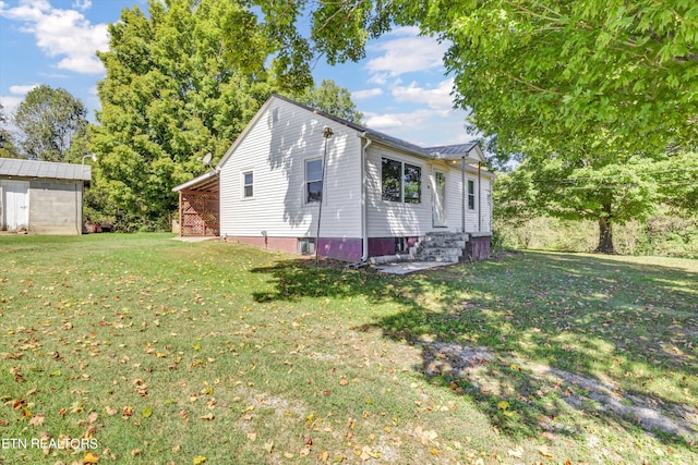 exterior space with a front lawn and a storage unit