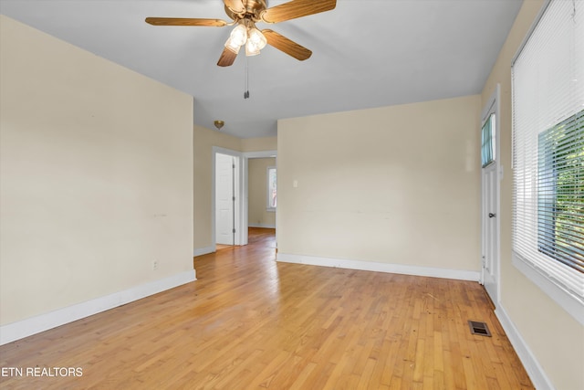 spare room featuring light hardwood / wood-style flooring and ceiling fan