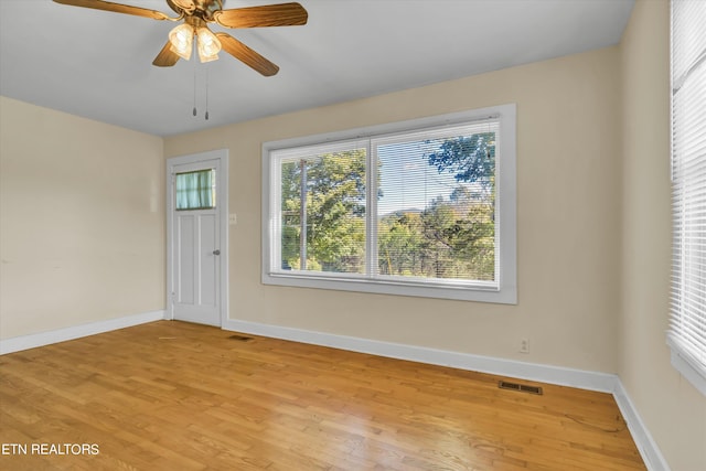 empty room with light hardwood / wood-style flooring and ceiling fan