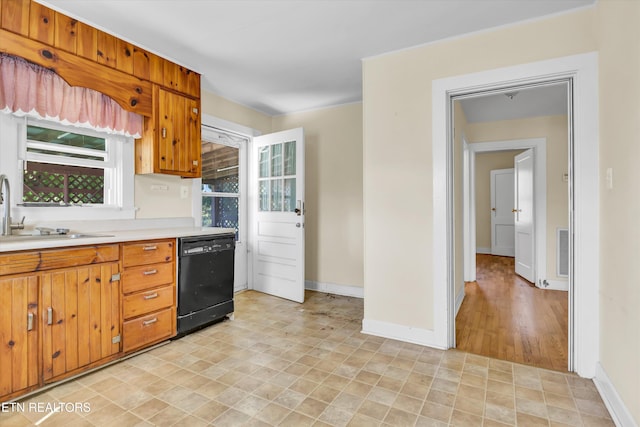 kitchen featuring light hardwood / wood-style floors, sink, and black dishwasher