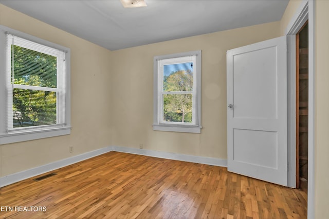 empty room with light hardwood / wood-style flooring