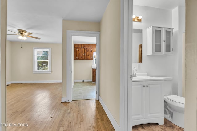 bathroom featuring hardwood / wood-style floors, vanity, toilet, and ceiling fan