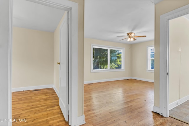 empty room featuring ceiling fan and light hardwood / wood-style flooring