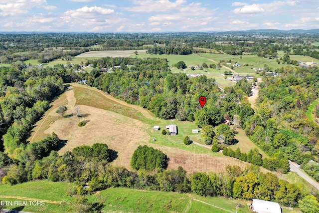 birds eye view of property with a rural view