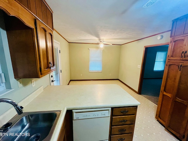 kitchen featuring ceiling fan, dishwasher, sink, crown molding, and a textured ceiling