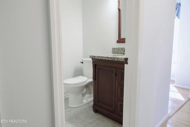 bathroom featuring vanity, toilet, and tile patterned floors