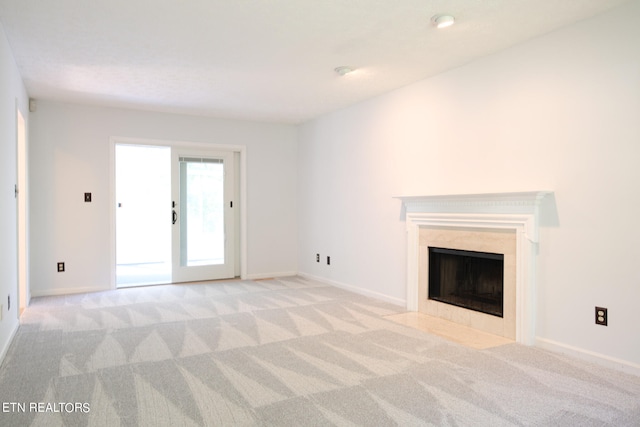 unfurnished living room featuring light colored carpet