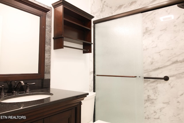 bathroom featuring an enclosed shower and vanity