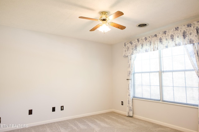 empty room featuring light carpet and ceiling fan