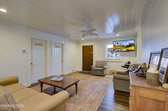 living area with ceiling fan, dark wood finished floors, ornamental molding, recessed lighting, and wooden ceiling