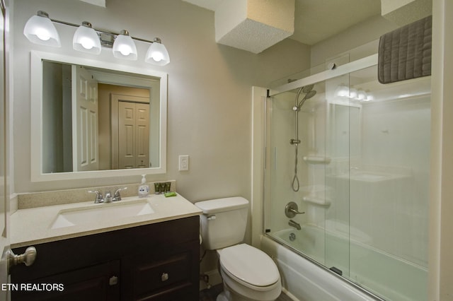 full bathroom featuring toilet, vanity, and combined bath / shower with glass door