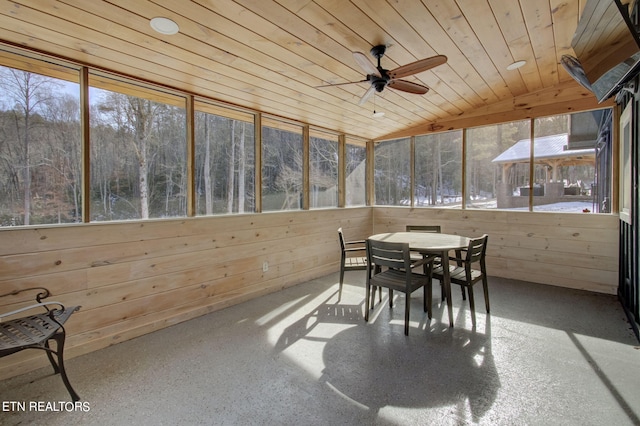 sunroom featuring ceiling fan and outdoor dining space